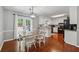 Eat-in kitchen featuring white cabinets, granite countertops and wood flooring at 831 Terrace Trce, Lawrenceville, GA 30044