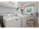 Laundry room featuring a washer and dryer, a window and overhead cabinets at 831 Terrace Trce, Lawrenceville, GA 30044