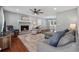 Cozy living room featuring a stone fireplace, ceiling fan and wood flooring at 831 Terrace Trce, Lawrenceville, GA 30044