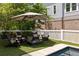Inviting backyard features outdoor seating with an umbrella, and a small in-ground pool at 10559 Serenbe Ln, Chattahoochee Hills, GA 30268