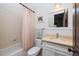 Cozy bathroom with neutral tile, a tub/shower combination, and marble vanity top offering a clean design aesthetic at 10559 Serenbe Ln, Chattahoochee Hills, GA 30268