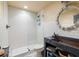 Modern bathroom with a white tiled shower and a unique vanity, showcasing contemporary design and functionality at 10559 Serenbe Ln, Chattahoochee Hills, GA 30268