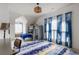 Bright bedroom features bunk beds, a sloped ceiling, and blue accents, creating a fun and inviting space at 10559 Serenbe Ln, Chattahoochee Hills, GA 30268