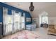 Charming bedroom with blue walls, a trundle bed, and natural light, perfect for a space at 10559 Serenbe Ln, Chattahoochee Hills, GA 30268
