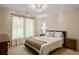 Inviting bedroom features neutral tones, a patterned comforter, and ample natural light for a serene retreat at 10559 Serenbe Ln, Chattahoochee Hills, GA 30268