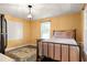 Cozy bedroom with hardwood floors, a wrought iron bed frame, and warm colors creating a relaxing atmosphere at 10559 Serenbe Ln, Chattahoochee Hills, GA 30268