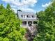 Charming two-story home with a welcoming front porch and beautifully landscaped surroundings at 10559 Serenbe Ln, Chattahoochee Hills, GA 30268
