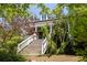 Stately home featuring a long, elevated porch with elegant white columns and a grand staircase at 10559 Serenbe Ln, Chattahoochee Hills, GA 30268
