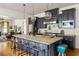 Charming kitchen with a large island, modern appliances, and a seamless connection to the living area at 10559 Serenbe Ln, Chattahoochee Hills, GA 30268