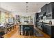 Well-appointed kitchen with dark cabinets, a large island, and a seamless flow to the dining area at 10559 Serenbe Ln, Chattahoochee Hills, GA 30268