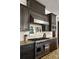 Gourmet kitchen boasts granite countertops, stainless steel Viking appliances, and custom cabinetry for a luxurious cooking experience at 10559 Serenbe Ln, Chattahoochee Hills, GA 30268