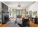 Bright living room featuring a fireplace, modern decor, and french doors leading to the backyard at 10559 Serenbe Ln, Chattahoochee Hills, GA 30268