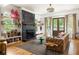 Stylish living room featuring hardwood floors, a cozy fireplace, and French doors leading to the outdoors at 10559 Serenbe Ln, Chattahoochee Hills, GA 30268