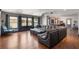 Spacious living room with a large sectional sofa and hardwood floors, ideal for entertaining and relaxation at 10559 Serenbe Ln, Chattahoochee Hills, GA 30268