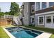 This in-ground gunite pool is surrounded by artificial grass and a retaining wall at 10559 Serenbe Ln, Chattahoochee Hills, GA 30268