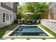 A gunite pool with seating area, an umbrella and lounge chairs provides a relaxing spot at 10559 Serenbe Ln, Chattahoochee Hills, GA 30268