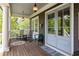 Relaxing porch featuring rocking chairs and a swing, with views of the lush surroundings at 10559 Serenbe Ln, Chattahoochee Hills, GA 30268
