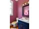 Unique powder room showcases vibrant wallpaper, a navy vanity, and whimsical design elements for a fun and stylish space at 10559 Serenbe Ln, Chattahoochee Hills, GA 30268