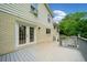 White brick home with back deck featuring white french doors, gray deck and gray railing at 1448 Drayton Woods Dr, Tucker, GA 30084