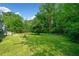 Expansive backyard with lush green grass, patio and beautiful mature trees at 1448 Drayton Woods Dr, Tucker, GA 30084