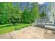 Spacious backyard featuring patio, green grass, lush green trees, and deck at 1448 Drayton Woods Dr, Tucker, GA 30084