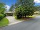 Asphalt road leading to driveway and home featuring a carport at 1448 Drayton Woods Dr, Tucker, GA 30084