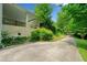 Concrete driveway with lush greenery and shrubbery lining the drive at 1448 Drayton Woods Dr, Tucker, GA 30084
