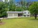 Well-maintained home with lawn, charming lattice accent, inviting front porch and a black motorcycle at 1448 Drayton Woods Dr, Tucker, GA 30084