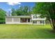 Charming home with a well-maintained lawn, a brick lattice accent, and a welcoming porch at 1448 Drayton Woods Dr, Tucker, GA 30084