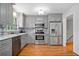Spacious kitchen with stainless steel appliances, light grey cabinetry, and hardwood floors at 1448 Drayton Woods Dr, Tucker, GA 30084