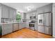 Modern kitchen featuring stainless steel appliances, subway tile backsplash and gorgeous hardwood floors at 1448 Drayton Woods Dr, Tucker, GA 30084