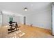 Large, open-concept living space featuring hardwood floors and an exercise machine at 1448 Drayton Woods Dr, Tucker, GA 30084
