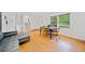 Bright living room features hardwood floors, a dining area, and a comfortable leather sofa at 1448 Drayton Woods Dr, Tucker, GA 30084