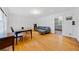 Spacious living room featuring hardwood floors, a dark leather sofa, and a dining area at 1448 Drayton Woods Dr, Tucker, GA 30084