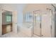 Bright bathroom featuring glass shower, garden tub, and an entryway to main bedroom at 1259 Crescentwood Ln, Decatur, GA 30032