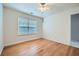 This bedroom features wood floors, neutral walls, a window, and ceiling fan at 1259 Crescentwood Ln, Decatur, GA 30032