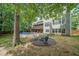 Expansive backyard featuring a fire pit, above-ground pool, and a spacious deck with outdoor seating, ideal for relaxation at 150 Shady Grove Ln, Alpharetta, GA 30009