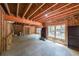 Spacious unfinished basement with exposed wood framing, large windows, and a concrete floor, offering potential for expansion at 150 Shady Grove Ln, Alpharetta, GA 30009