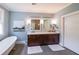 Bathroom boasts a clawfoot tub, dark wood vanity with double sinks, and neutral paint at 150 Shady Grove Ln, Alpharetta, GA 30009