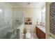 Bathroom with a glass enclosed shower, granite vanity, and tile flooring at 150 Shady Grove Ln, Alpharetta, GA 30009