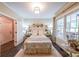 Inviting bedroom with large windows, neutral decor, and dark hardwood floors at 150 Shady Grove Ln, Alpharetta, GA 30009