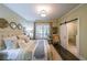 Comfortable bedroom with a queen bed, natural light, and ensuite bath with barn door at 150 Shady Grove Ln, Alpharetta, GA 30009