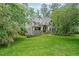 Charming two-story home boasts a meticulously landscaped yard and inviting covered front porch at 150 Shady Grove Ln, Alpharetta, GA 30009