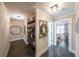Hallway with dark hardwood floors leading to a bedroom with swinging chair at 150 Shady Grove Ln, Alpharetta, GA 30009