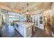 Open-concept kitchen with large island, granite countertops, and view to dining area at 150 Shady Grove Ln, Alpharetta, GA 30009