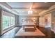 Beautiful bedroom with a tray ceiling, dark hardwood floors, and a cozy seating area at 150 Shady Grove Ln, Alpharetta, GA 30009