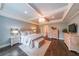 Luxurious main bedroom suite with tray ceiling, chandelier, and hardwood flooring at 150 Shady Grove Ln, Alpharetta, GA 30009