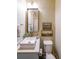 Stylish powder room featuring a vessel sink, modern faucet, and vertical striped wallpaper at 150 Shady Grove Ln, Alpharetta, GA 30009