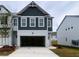 Two-story home featuring a painted brick front with an attached two car garage at 1956 Asher Ln # 51, Conyers, GA 30013