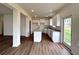 Spacious kitchen featuring granite countertops, white cabinets and an island at 1956 Asher Ln # 51, Conyers, GA 30013